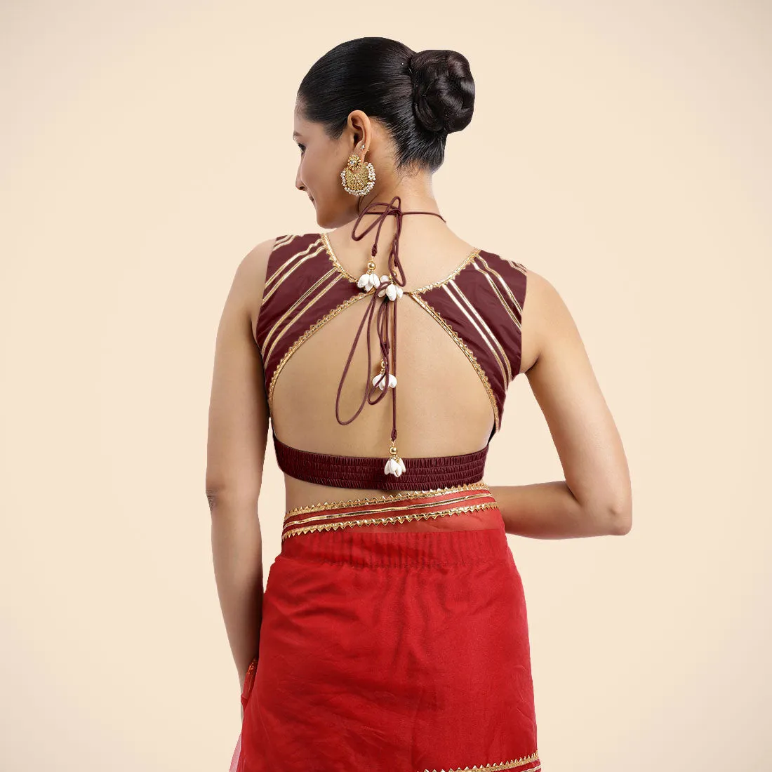 Ahana x Tyohaar | Burgundy Sleeveless FlexiFit™ Saree Blouse with Plunging Neckline and Back Cut Out with Tasteful Golden Gota Lace Embellishment